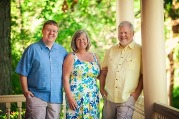 Corey, Linda and Bill Lack standing on their front porch