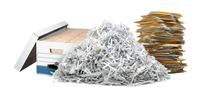 Box of file folders next to a pile of shredded paper and a stack of files