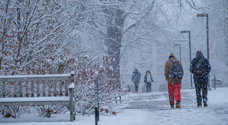 Students bracing against wind and snow outside