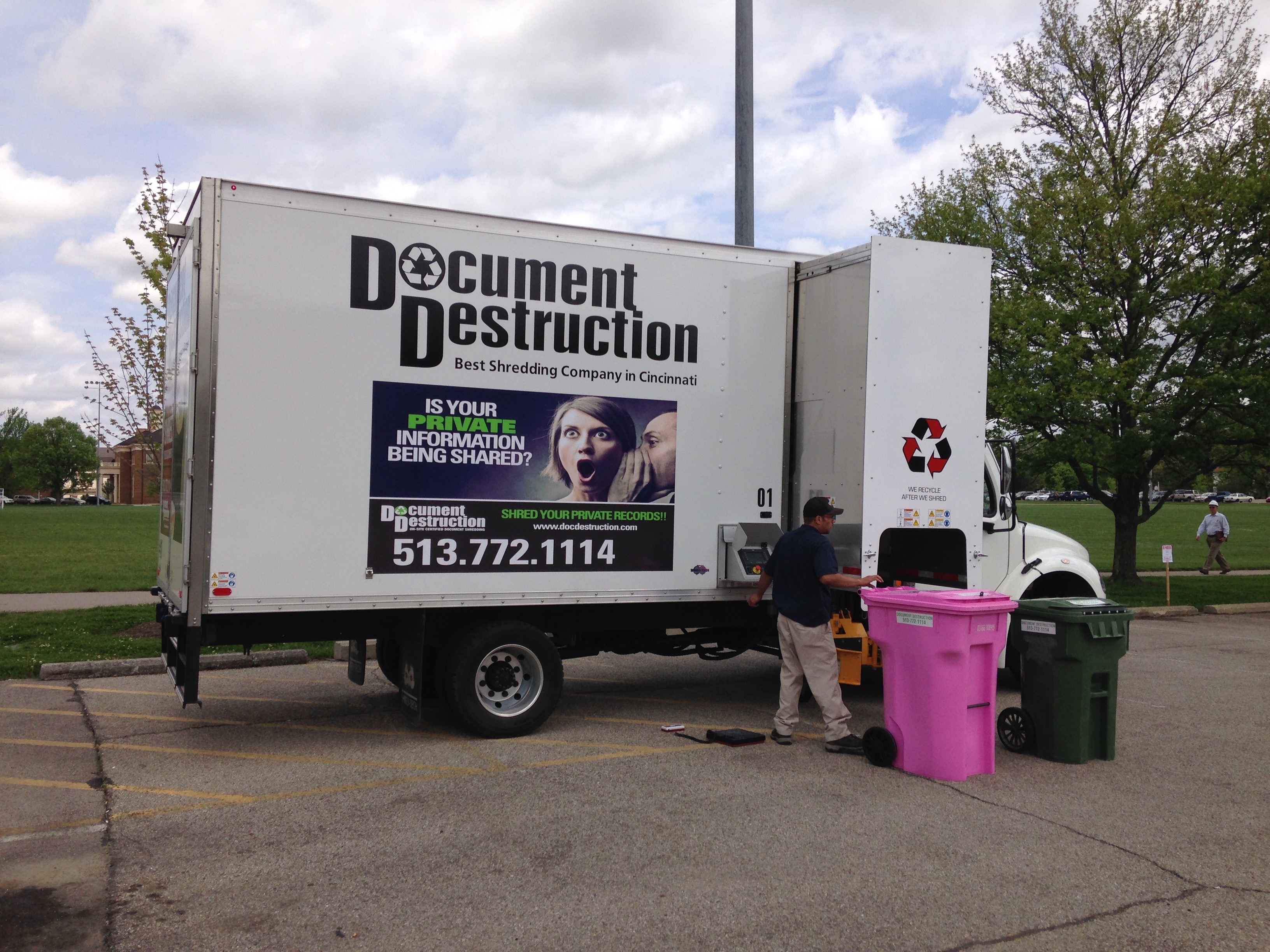 Shredding technician loading the shred truck near Cook Field.