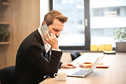 A businessman taking a phone call on his smart phone