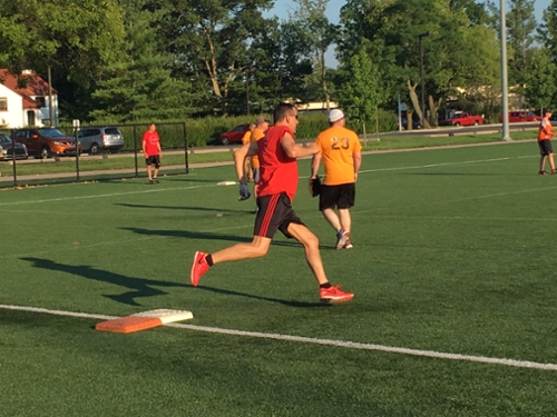 Brian Simms rounding first in a softball game at Cook Field