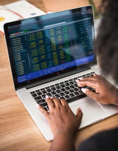 A laptop shown with hands poised above the keyboard