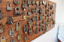 A wall of antique locks and keys