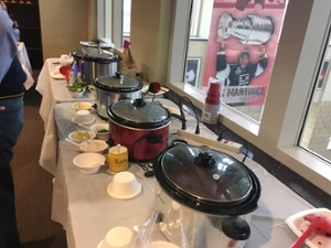Crock pots full of chili lined up on a table