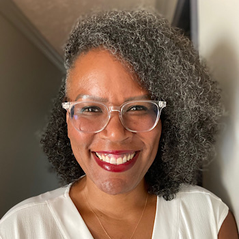 Trey Boynton, a dark-skinned woman with glasses, smiling at the camera