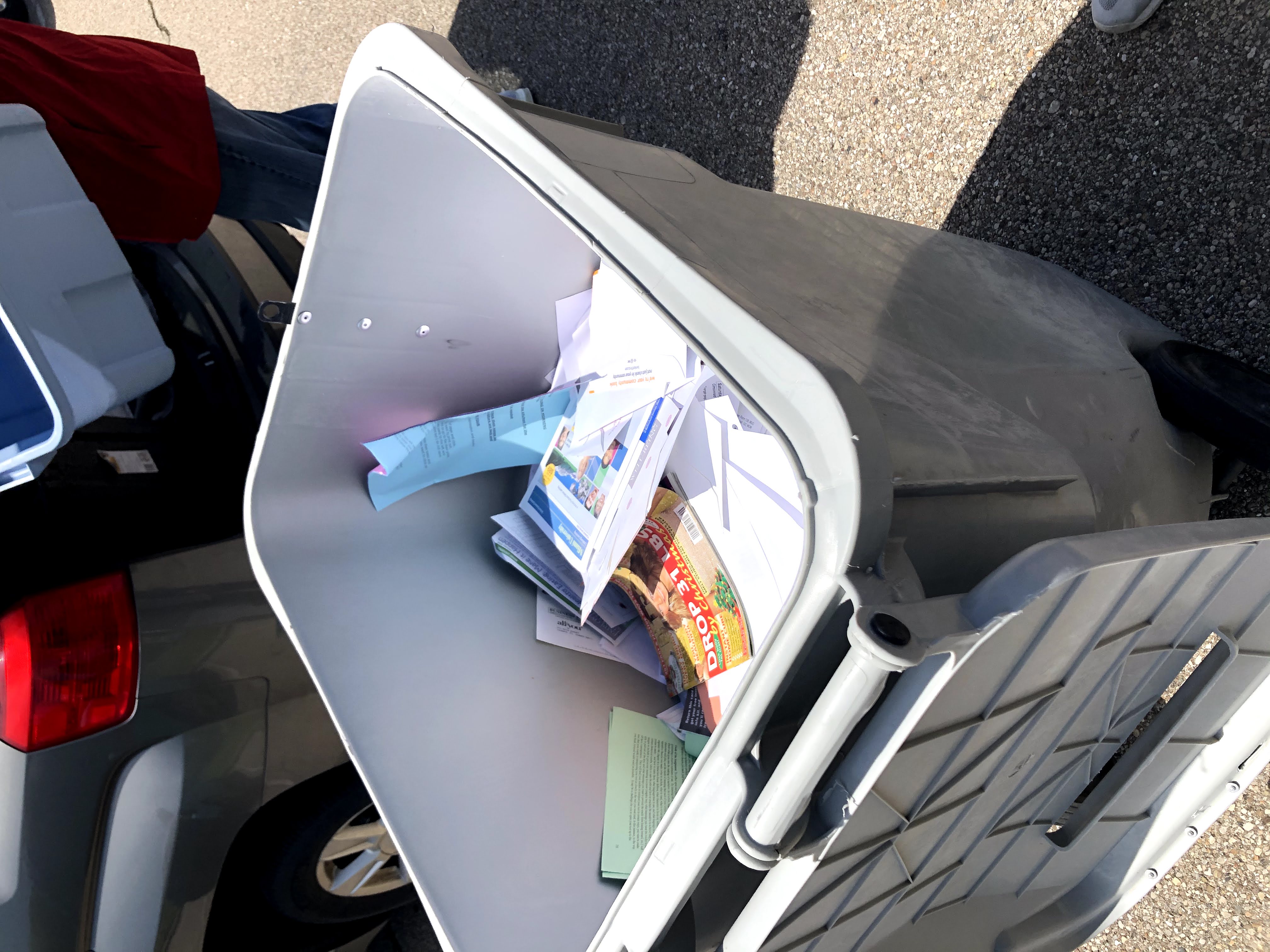 A bin filled with paper ready to be shredded