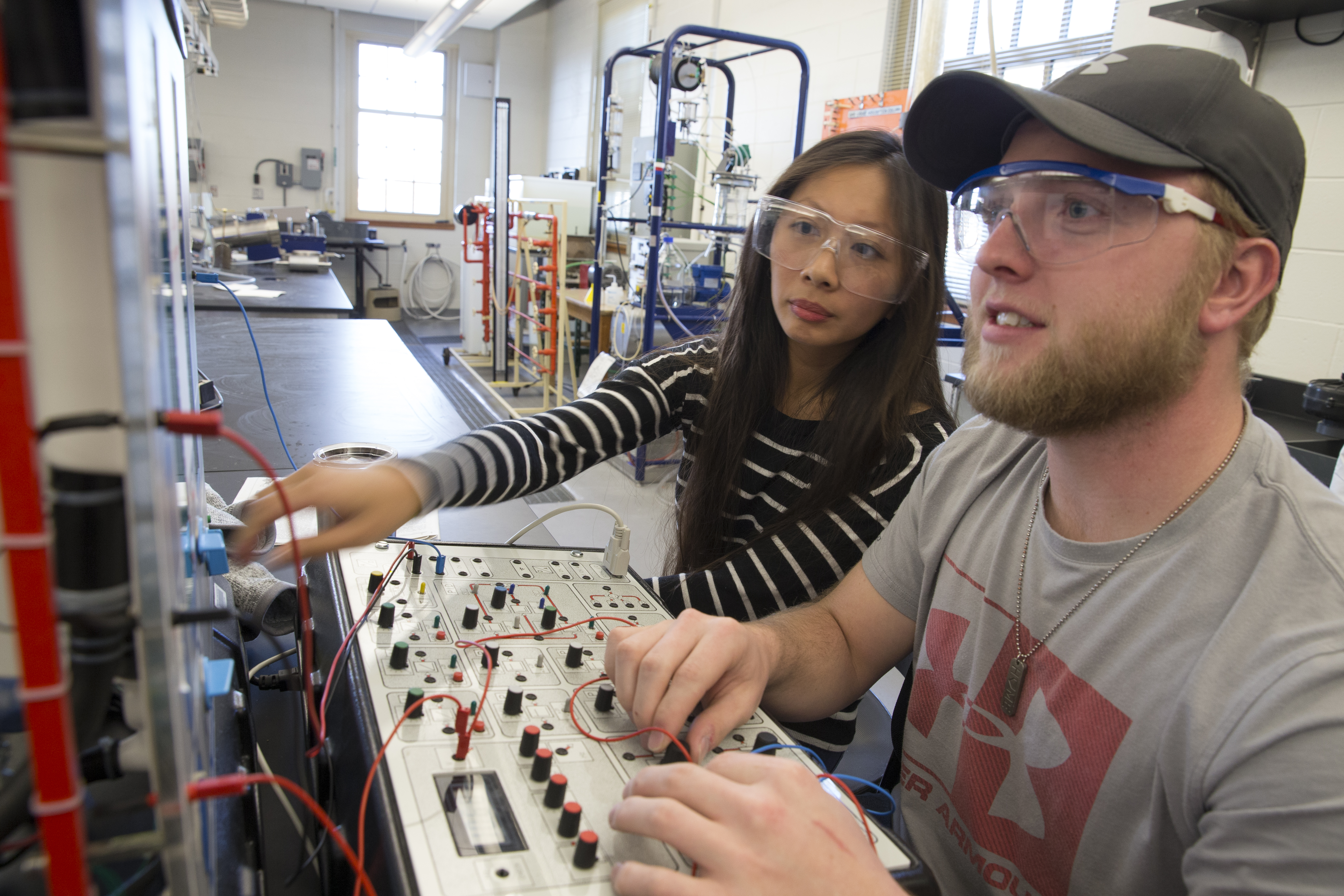 A male and a female student working together on an engineering project