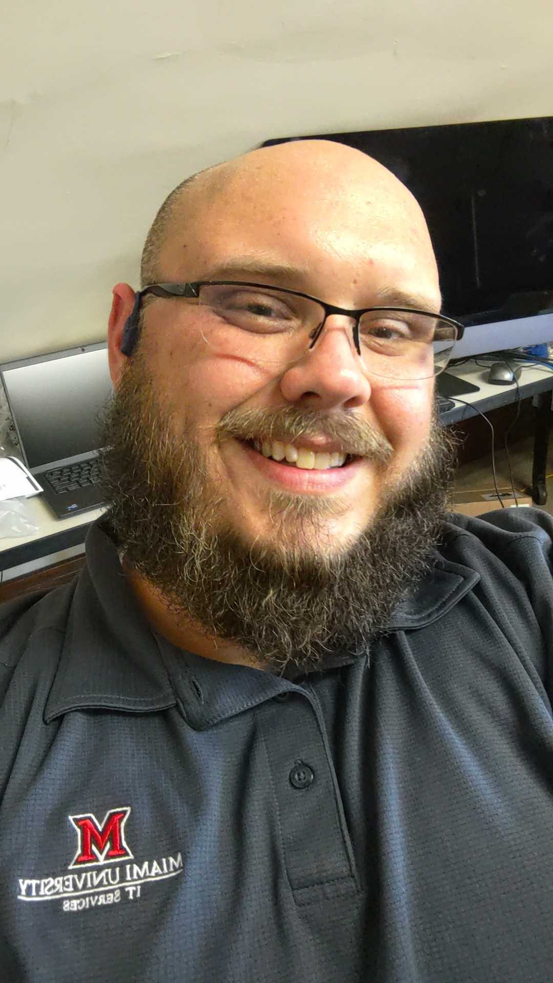 Headshot of Steven Harvey, a white bearded man with glasses