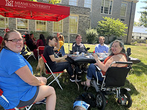 IT Services and friends have lunch together in the sunshine