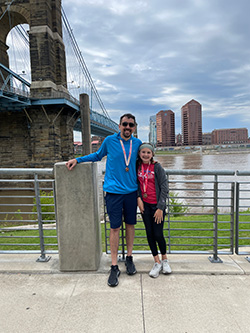 Josh Senn poses with his daughter after a marathon in downtown cincinnati