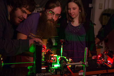 Students study atom and molecule reactions using ultrafast lasers.