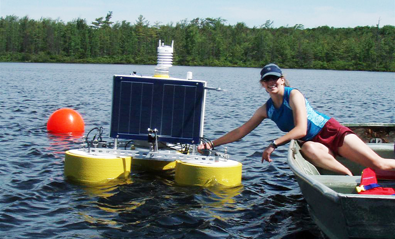 Jennie Brentrup, Miami doctoral student, with a buoy equipped with a suite of sensors to study the seasonal dynamics of dissolved organic carbon in Lake Lacawac. Brentrup is chair of the Global Lake Ecological Observatory Network (GLEON) Student Association.