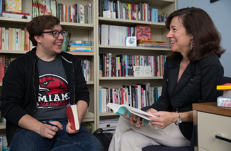 Eric Rubeo meets with his faculty mentor Margaret Luongo about his Undergraduate Summer  Scholar's project  on the relationship between author and narrator (photo by Scott Kissell).
