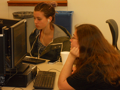 Two girls working on a coding problem.