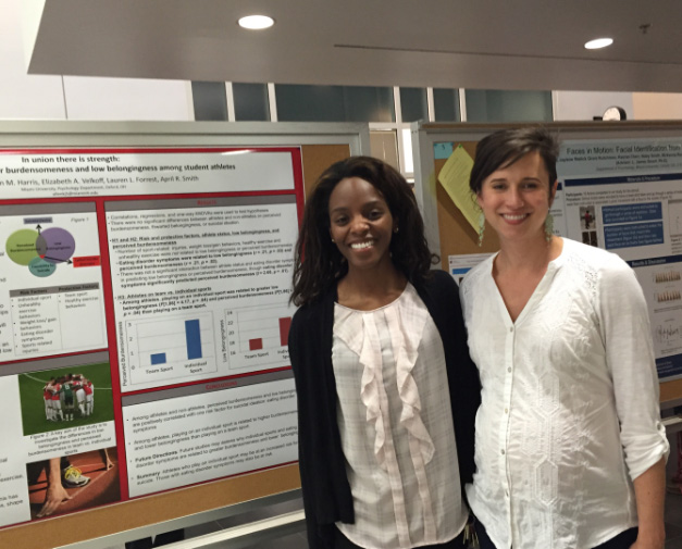 Kayla Allen with April Smith stand in front of her research poster