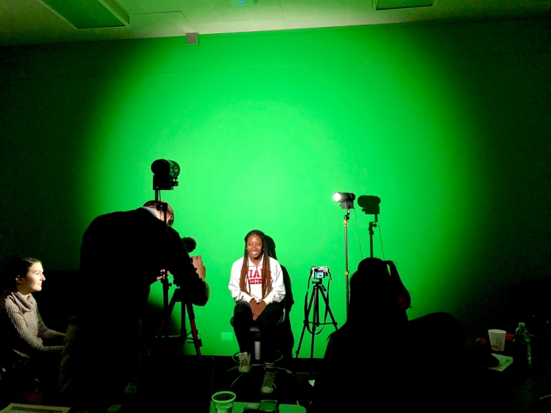 A Miami University student sits in front of a video recorder for an interview.