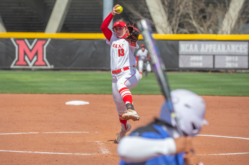 Miami softball pitcher Courtney Vierstra in the motion of pitching the ball to a waiting batter.