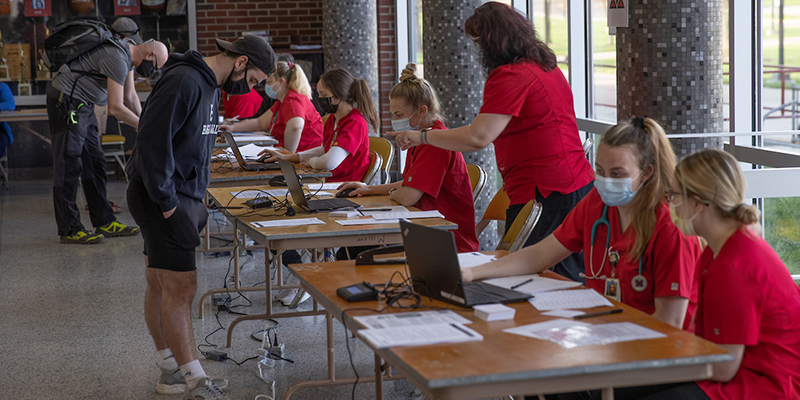 Nursing students register faculty and staff for the COVID-19 vaccine.