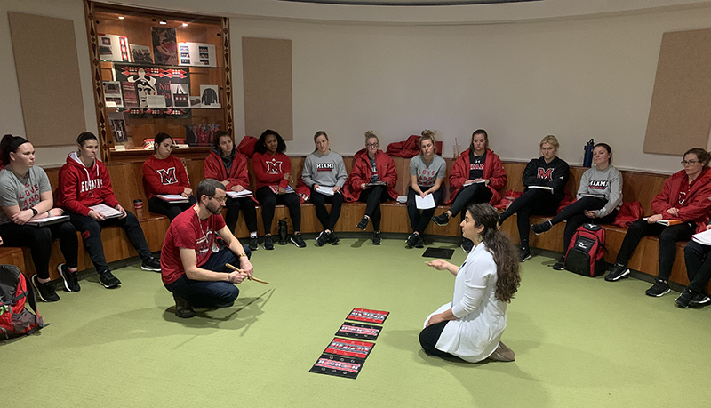 Miami softball team learning a traditional Myaamia game