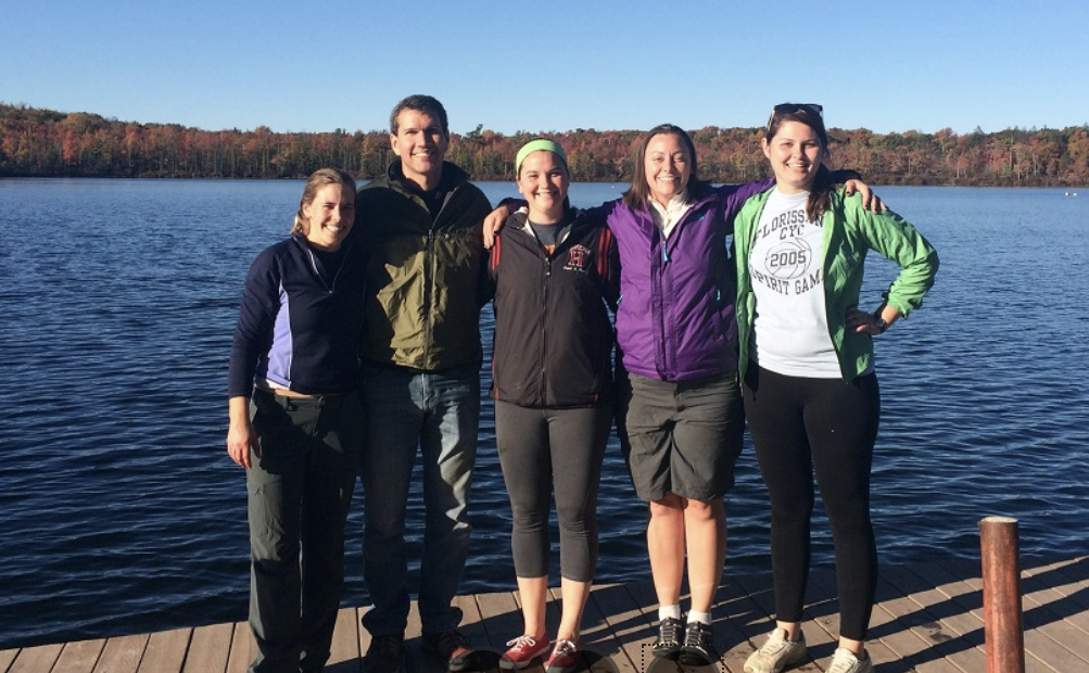 5 graduate students on a dock in a lake