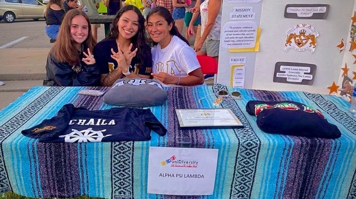 Alpha Psi Lambda students at a festival