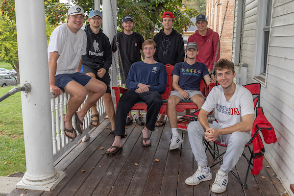 Will Olson sitting on a porch with friends