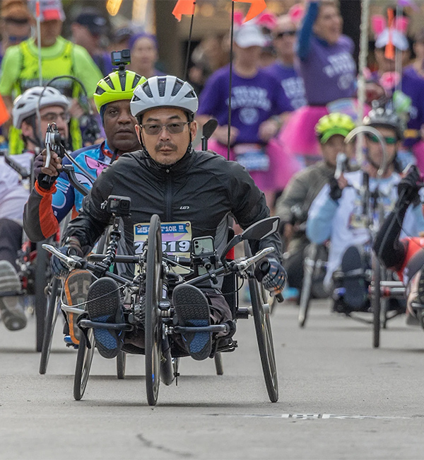 Yoshi and other Flying Pig 10K handcycle participants focus on the race