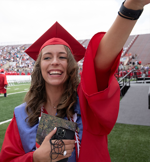 student celebrating after commencement