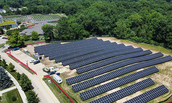 Aerial view of the construction of the solar field with many rows of solar panels installed