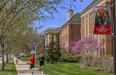 students jogging on campus
