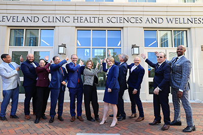 A group of Cleveland Clinic and university officials celebrating the naming of the Cleveland Clinic Health Sciences and Wellness facility