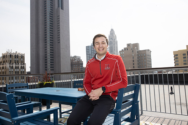 Michael Gallo sitting on a rooftop