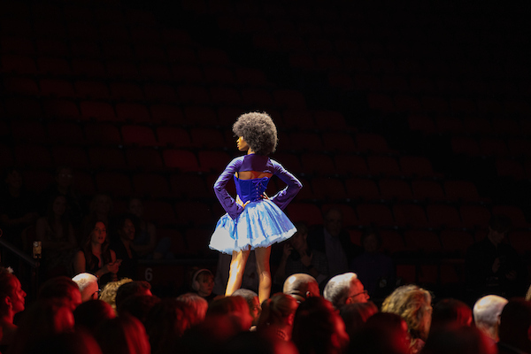 student modeling on a runway for a fashion show