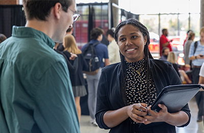 student talking with a recruiter at a past career fair