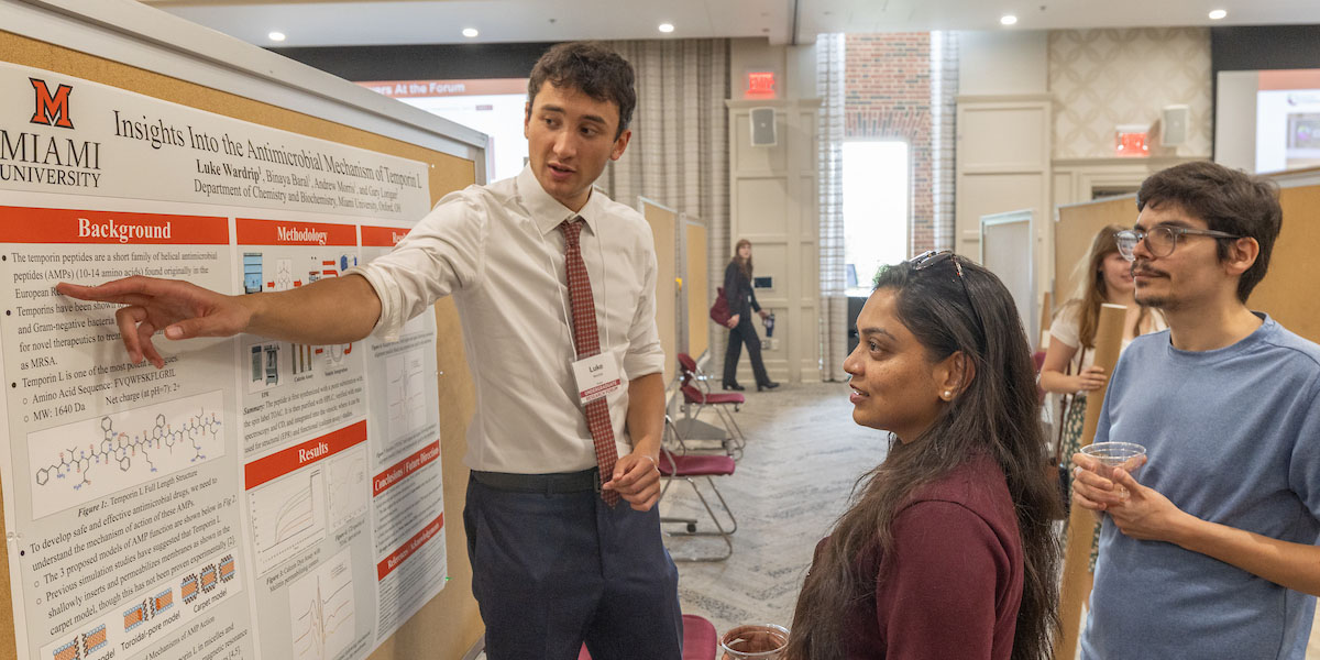 Miami student Luke Wardrip presents his research to visitors of the undergraduate research forum.