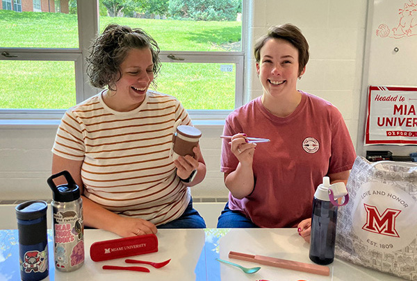 UCM art director Dani Cimino and senior graphic designer Kenzie Bryant, Miami's Sustainability Champion of the Year, with a selection of some of their favorite reusable items