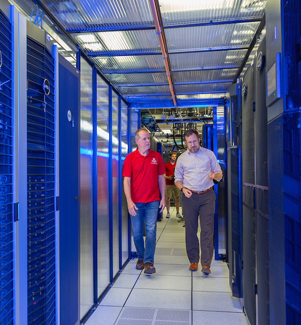 Mike Ritcher and David Seidl walk through the Bird Cage located within the data center at Hoyt Hall
