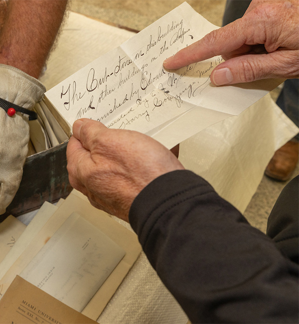 man reading a handwritten note from the time capsule