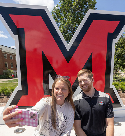 UCM staff members Maci Bowling and Zachary Burnett take a selfie at the new RedHawk Plaza.