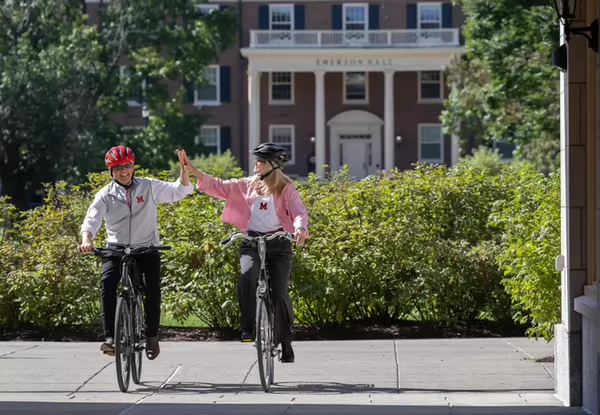 the Crawfords biking on campus on move-in day