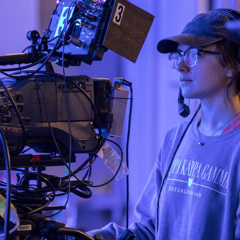 Miami students working with large filming equipment