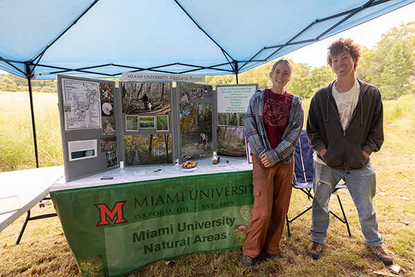 two students at the natural areas information table