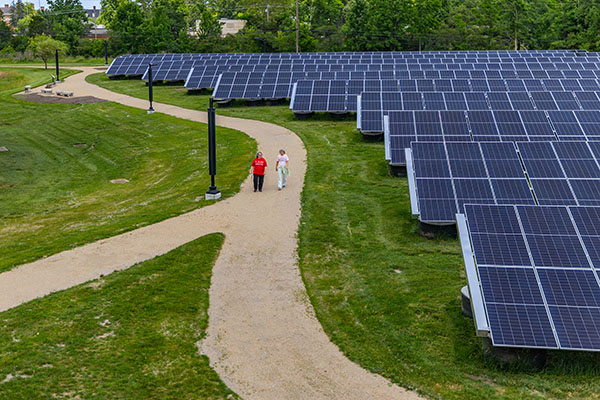 Mitchell Sustainability Park Western Solar North array and 2 people walking on path