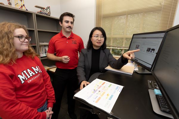 Faculty member, Jingjan She, working with 2 graduate students.