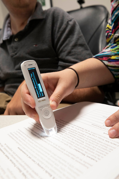 Text-to-Voice eletronic pen scanning words on paper.