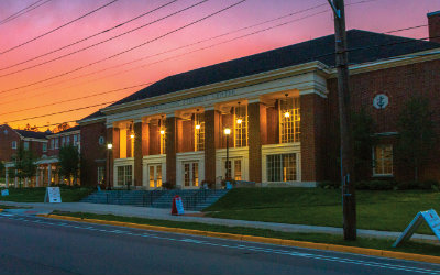 Armstrong Student Center taken at dusk with a pink and purple sky in the background