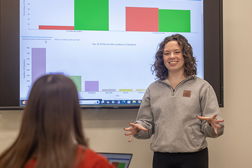 A collection of brochures and flyers promoting various programs and events, displayed on a red background.