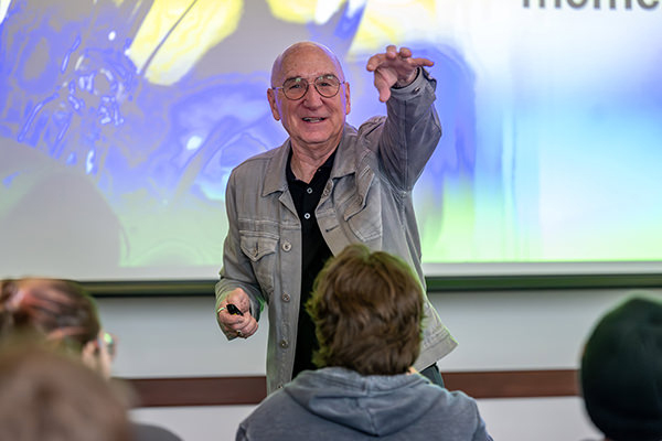 Speaker John Baird gestures towards a crowd during his presentation at the Perlmutter Conference through the Wilks Leadership Institute