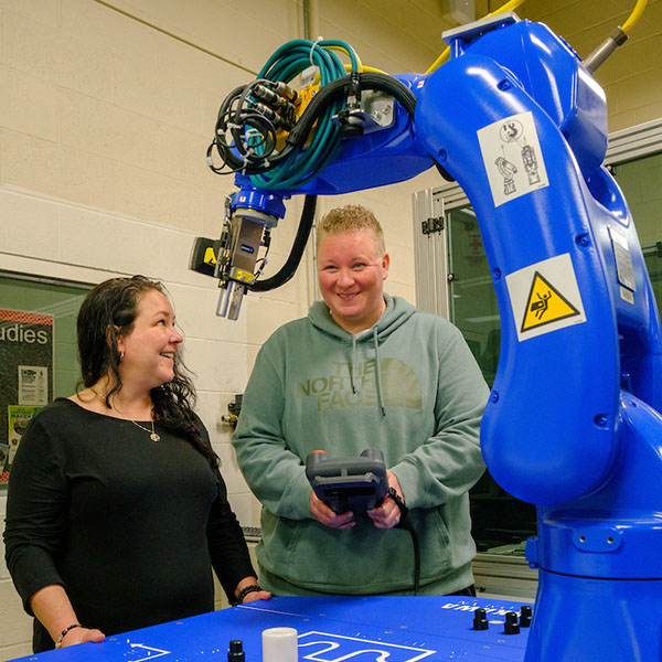 Student and faculty member interacting in the robotics lab